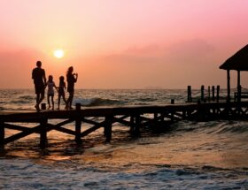 people standing on dock during sunrise